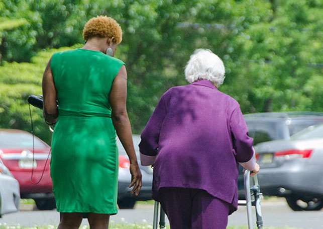 older woman walking with walker