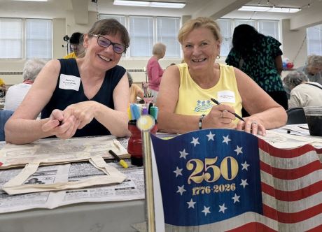 two women volunteers making crafts